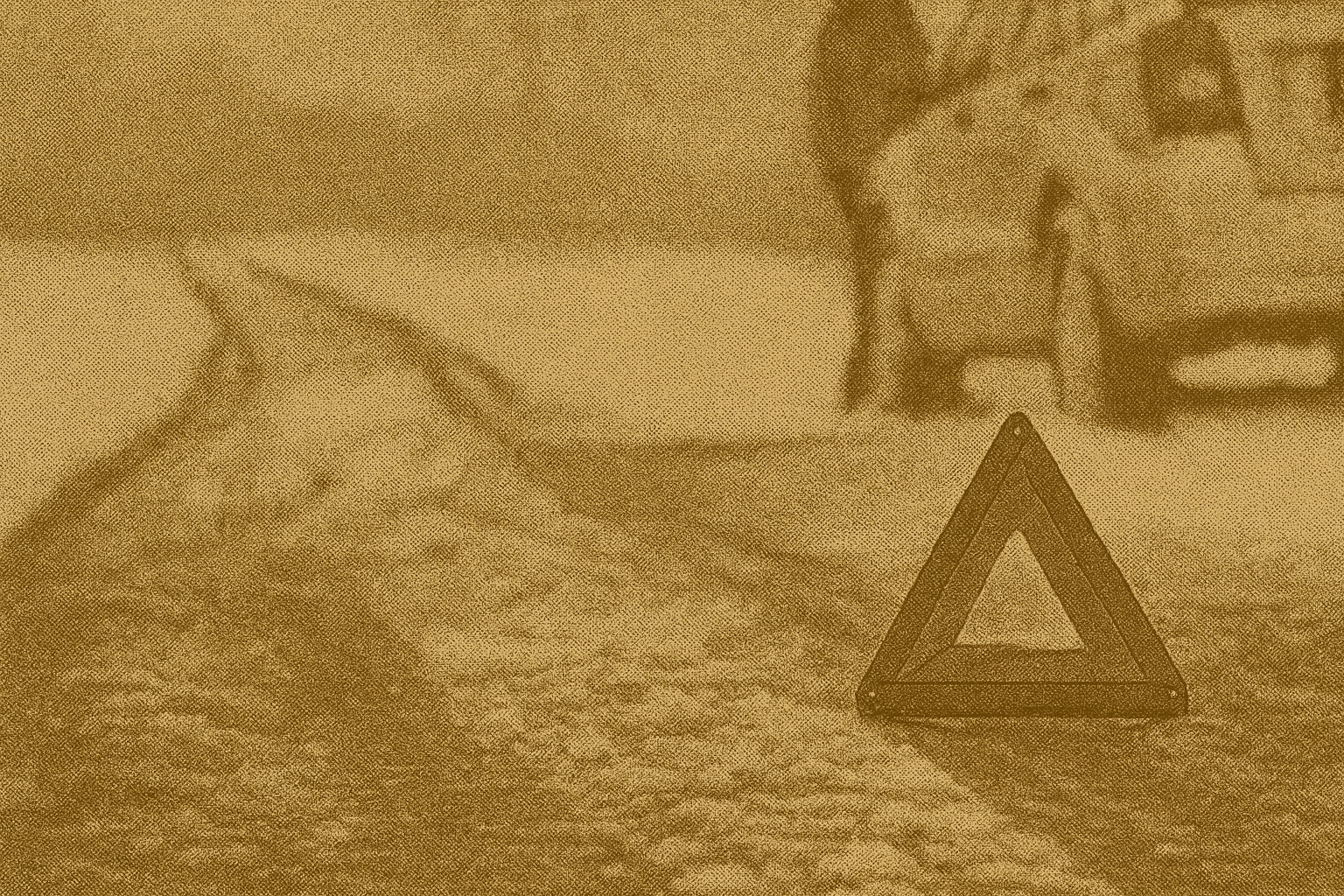 Driver wearing a high-visibility vest setting reflective triangles behind a car on a snowy roadside