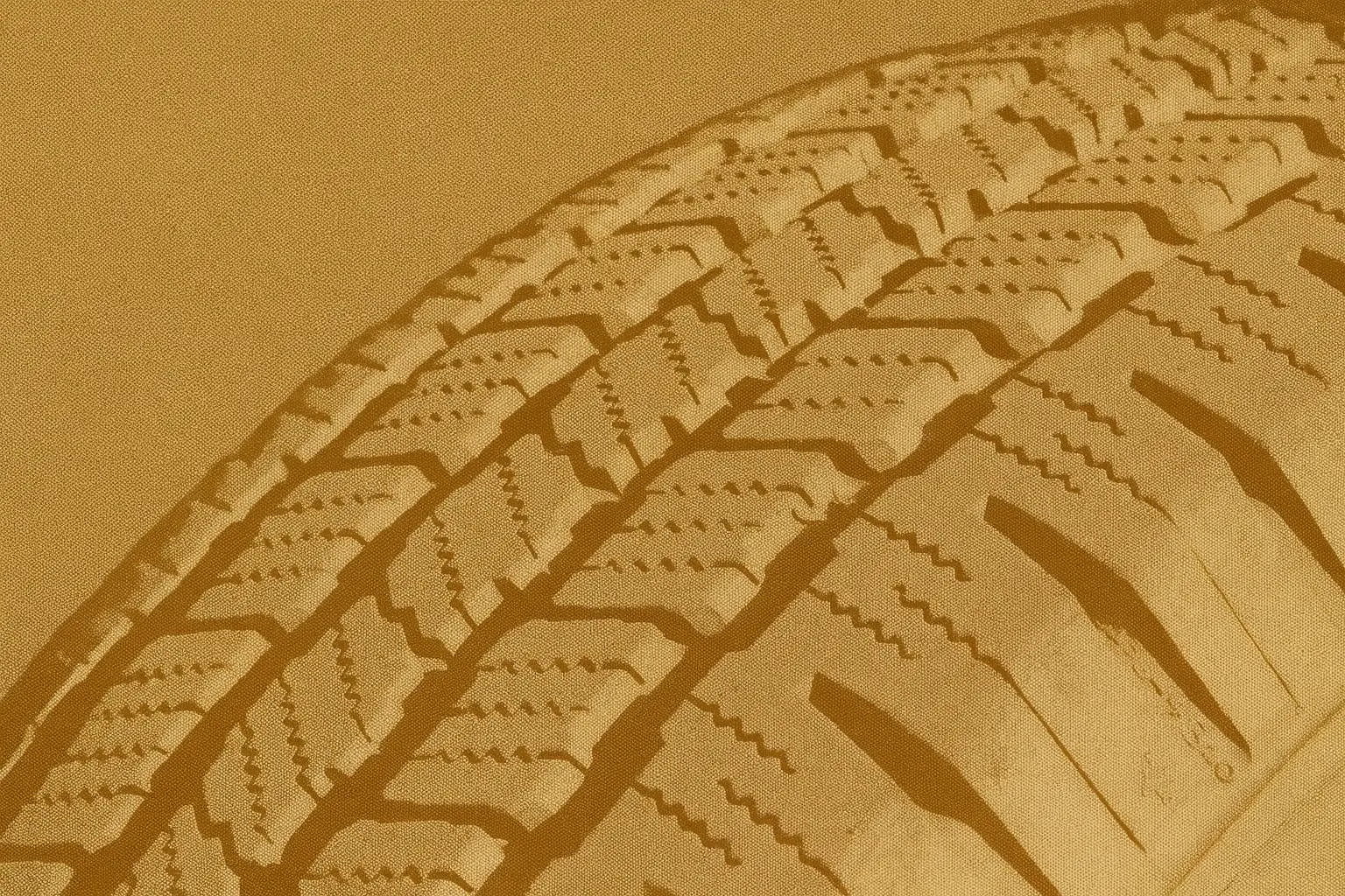 Close-up of winter tire tread showing deep grooves and sipes