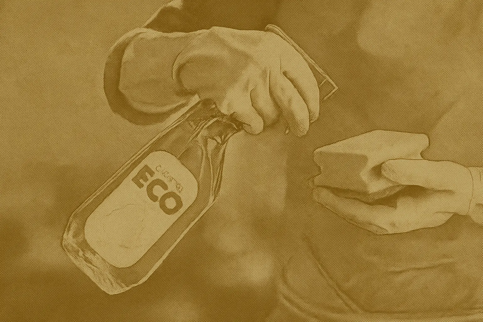Person wearing rubber gloves cleaning with a reusable sponge and a bottle labeled “ECO cleaner” — representing eco-friendly cleaning products used in Canadian homes.
